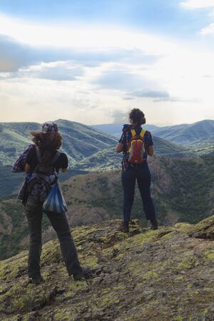 Beautiful landscape with young tourists in high mountain