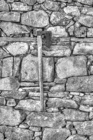 Stylish stone wall background and axe in black and whiteの写真素材