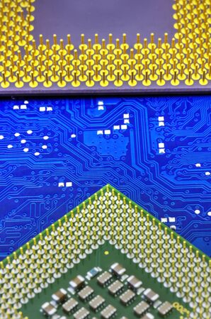 Technological background with computer motherboard and central processing units closeup