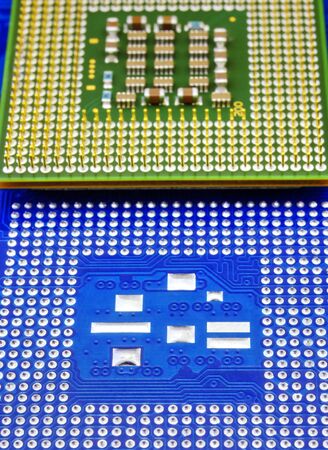 Technological background with blue computer motherboard and central processing unit closeupの写真素材