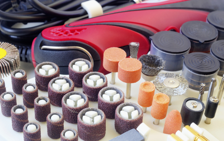 Mini drill machine with set of different grinding and cutting accessories closeupの写真素材