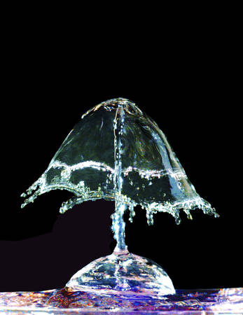 Colorful liquid splash on black background closeupの写真素材