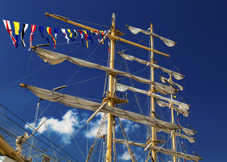 Masts of sailing ship on blue sky