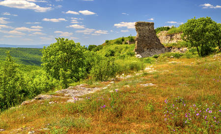 Beautiful summer landscape in the mountain range and ruins of ancient fortressの写真素材