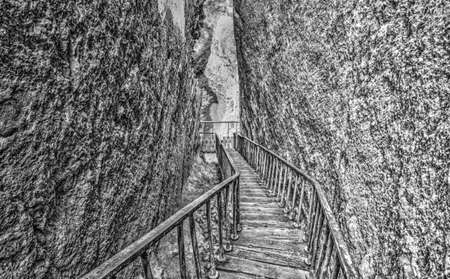 Beautiful view with stairs in the cave in black and whiteの写真素材