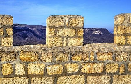 A look thru the wall of an ancient fortress to the mountains outside