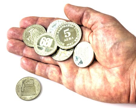 A pile of anniversary coins of republic of Bulgaria in a human's hand isolated on white background close up viewの写真素材
