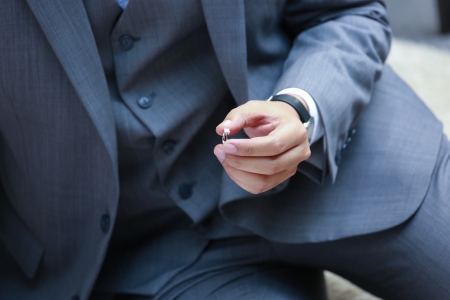 Wedding ring is prepared for the bride in the groom's hand