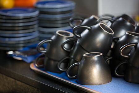Empty coffee cups are ready on the plate