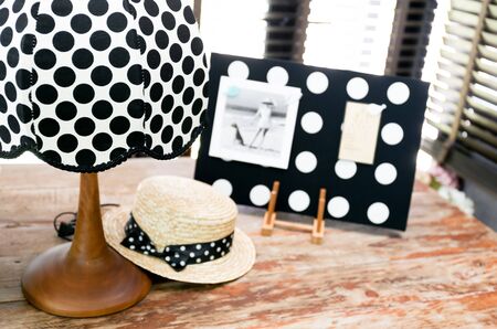 Polka dot vintage lamp on a wooden tableの写真素材