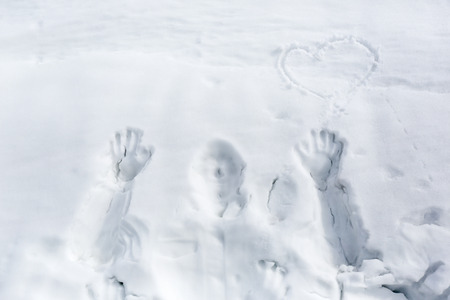 Sign of a heart and man on snow surfaceの写真素材