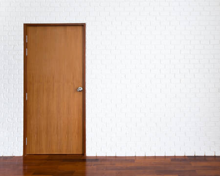 White brick wall with wooden doorの写真素材