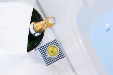 Champagne glass and whirlpool Spa with colourful light whirlpoolの写真素材