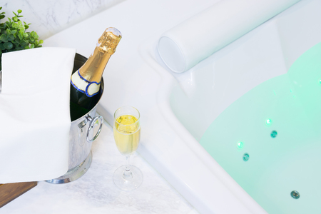 Champagne glass and whirlpool Spa with colourful light whirlpoolの写真素材