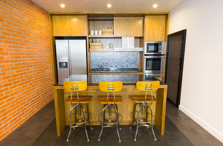 Stylish modern contemporary kitchen with island bar, chair and home appliancesの写真素材