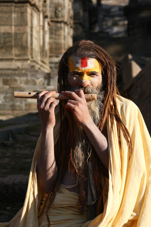 KATHMANDU, NEPAL-DECEMBER, 2009 - An unidentified ascetic or sadhu in pashupatinath temple waiting for travellers to take pictures in exchange with some moneyのeditorial素材