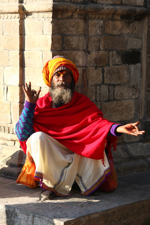 KATHMANDU, NEPAL-DECEMBER, 2009 - An unidentified ascetic or sadhu in pashupatinath temple waiting for travellers to take pictures in exchange with some moneyのeditorial素材