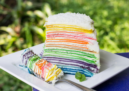 rainbow crepe cake on white plate