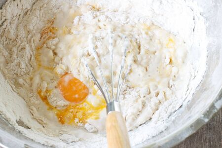 mixed yolk eggs, flour and sugar prepare for baking cake or bakeの写真素材