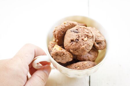 chocolate and hazelnut cookies in a cup with pancake in the morningの写真素材