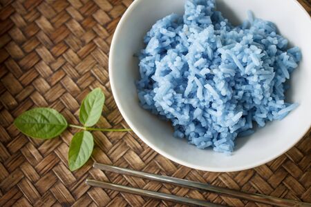 Blue Rice In China Cup color made from butterfly peas. object on bamboo background.の写真素材