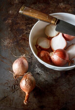 still life image of organic red shallot prepare for cooking put on grunge tray background image dark tone.の写真素材
