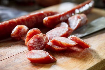 sliced chinese sausage sliced for cook put on cutting boardの写真素材