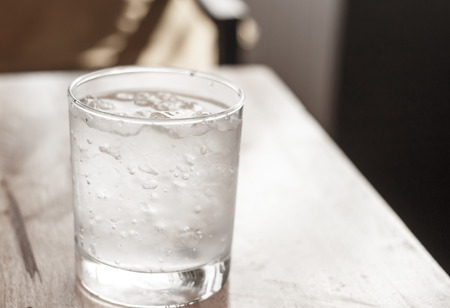 glass of cold water on tableの写真素材