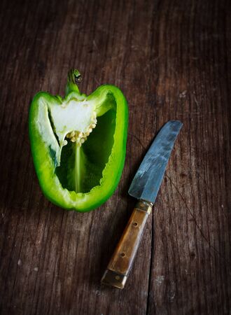 cut bell pepper on old wood background prepare for cookの写真素材