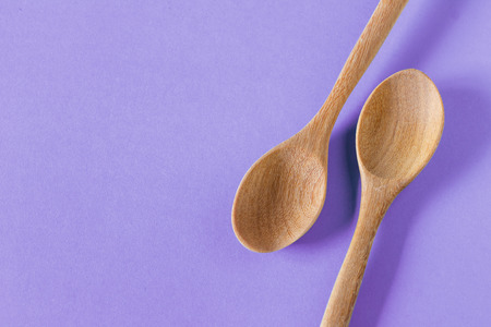 old wooden cooking spoon on purpld backgroundの写真素材