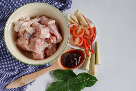 RAw food: ingredients for "Tom yum gai" or Spicy soup with chicken put on white wood table. Popular Thai food from top view.の写真素材