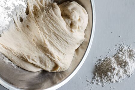 Yeast dough of homemade bread or pizza on wooden board