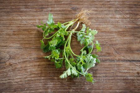Coriander with sack put on old wooden