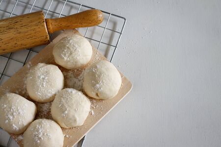 Yeast dough of homemade bread or pizza on wooden board
