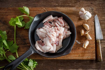 raw pork belly slice on a small pan with vegetable prepare for cookingの写真素材