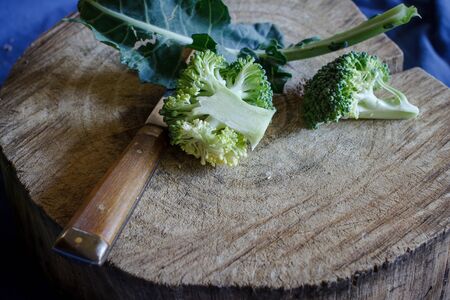 organic broccoli fresh from fram with old cutting board prepare for cook, image dark toneの写真素材