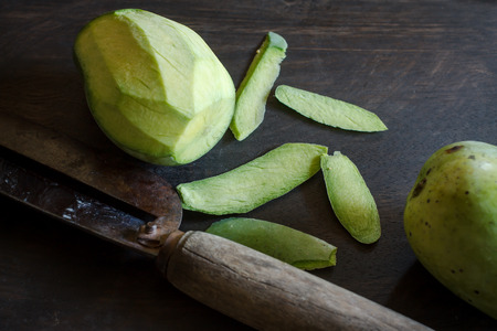 mango on old wooden with knifeの写真素材