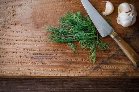 organic dill with garlic prepare for cook, rustic food put on wooden cutting boardの写真素材