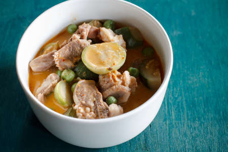 red curry with pork Thai food put on green wood tableの写真素材