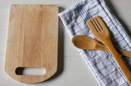 kitchen cooking utensils; wooden spoon with napkin object put on vintage white table