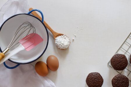 various of baking tool with chocolate muffin on white background.