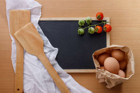 organic tomato, eggs in paper bag with blackboard for note. flat lay image.の写真素材