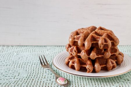 homemade chocolate waffle served in white plate.の写真素材