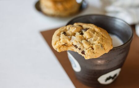 Delicious chocolate chip cookies with fresh milk in China cup.の写真素材