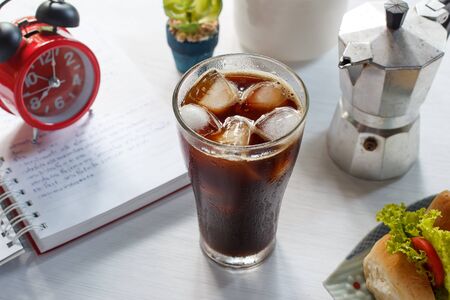 Glass of cold iced coffee with sandwich.の写真素材