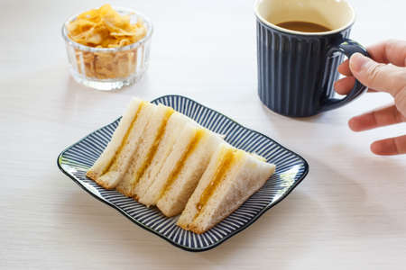 delicious sandwich with black coffee in blue cup.の写真素材
