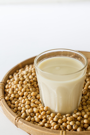 glass of soy milk, soy beans in bamboo basket.の写真素材