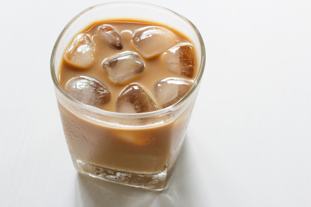 Glass of cold iced coffee on white table.の写真素材