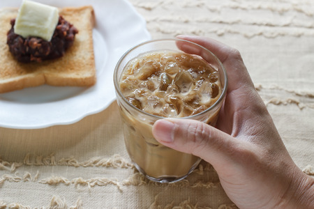 Glass of cold iced coffee on cloth background.の写真素材