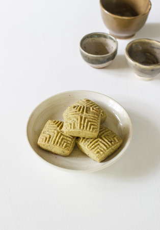 Homemade matcha green tea cookies on white table.の写真素材